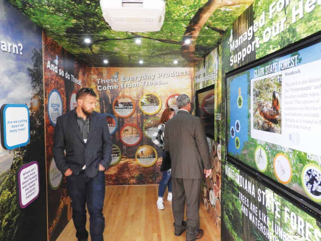 Members of IHLA tour the inside of the Woods on Wheels exhibit.