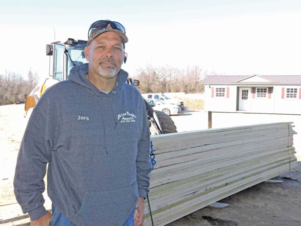 Joey Gray, general manager, stands in front of 5/4 FAS Poplar lumber ready for shipment.