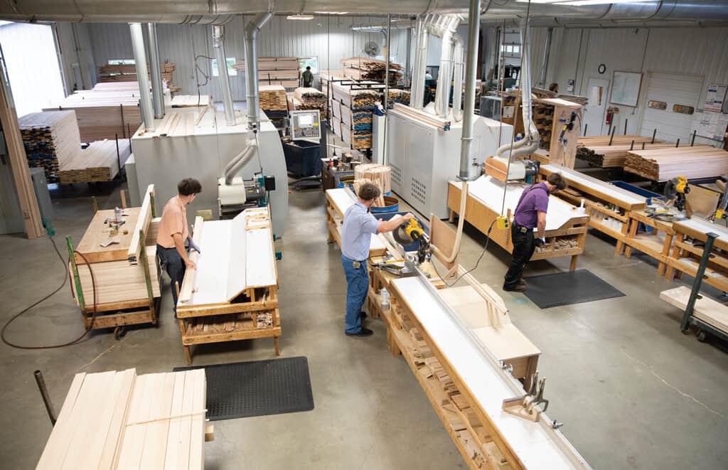 In the milling department, mouldings are inspected for defects, cut to length and stacked on carts. On an average day, Cornerstone Moulding runs about 28,000 lineal feet of moulding.