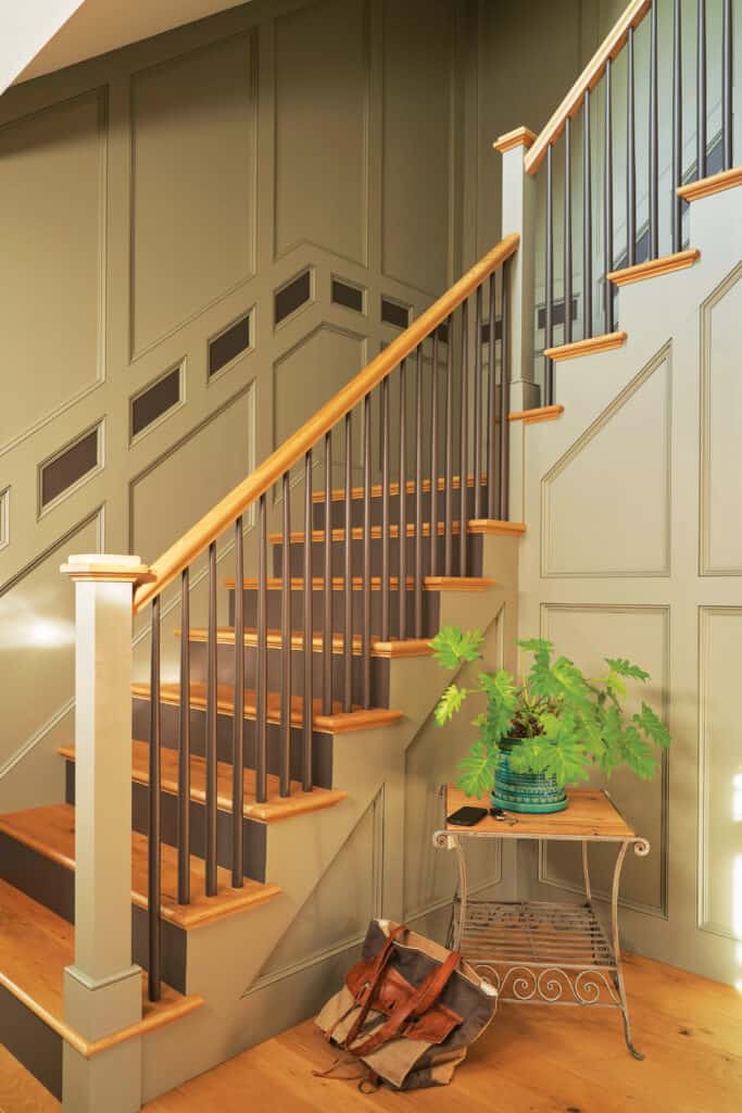 This custom staircase, with painted Poplar mouldings, trim and handrail, is finished with custom White Oak stair treads.