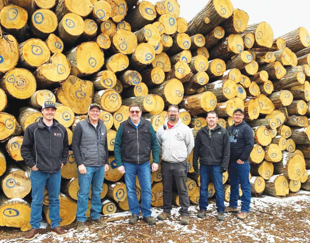 Chestnut saw logs ready to be milled at AAA Hardwoods in Weyauwega, WI. Pictured left to right: William Sprink, Tim Sprink, International Veneer & Timber (IVT), Gus Welter, Shannon Treankler and Shane Underwood (Granite Valley Forest Products) and Shannon Underwood (IVT).
