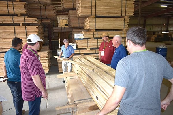 Lon Sibert of Renewable Resource Associates, Atlanta, GA, applies grade rules to a Poplar board during structural grading workshop at AHMI Fall Conference.