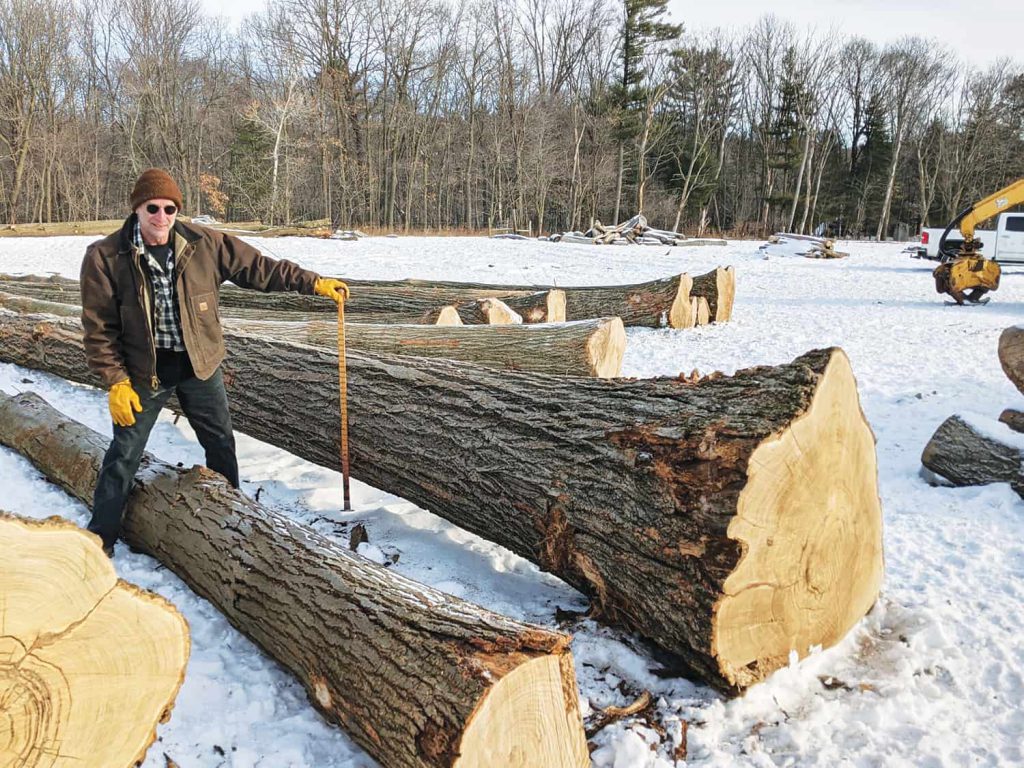 Larry Stewart is pictured with a Prime American Chestnut veneer log