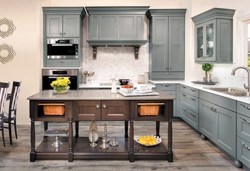 The perimeter wall cabinetry in Wellborn Cabinet’s Messina door style with a Willow paint finish is accented even further by the Cherry island in their Espresso finish.