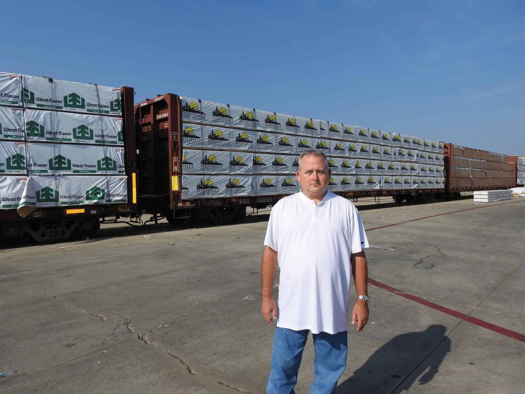 Co-owner of Oldham Lumber, Harley “Bubba” Finnell Jr. is pictured with rail cars ready to be unloaded.
