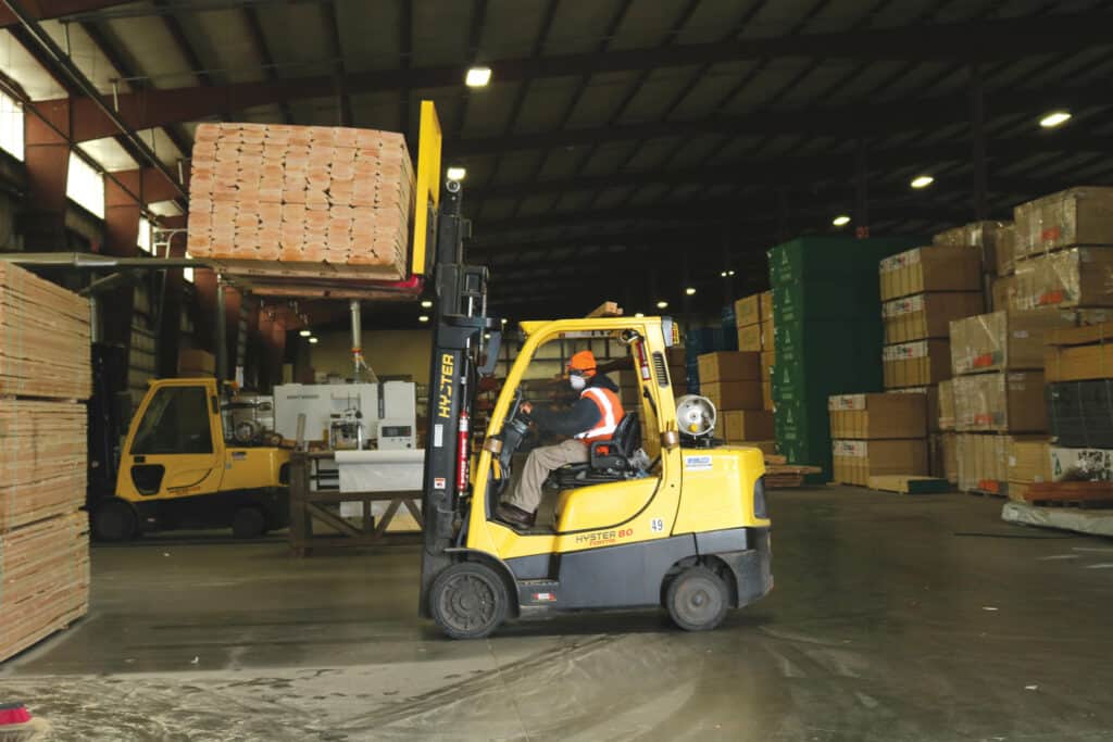 An FPS forklift driver lifts a unit of lumber in the company’s Kansas City facility.