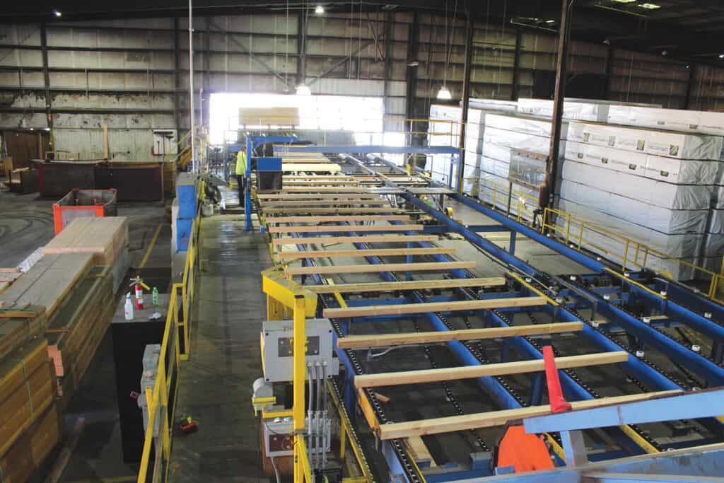 In the tray sorter grading zone, each piece of lumber is inspected by a certified lumber grader.