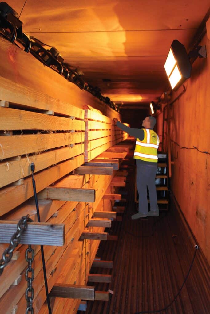 An Elk Creek Forest Products worker checks the moisture content of lumber in a kiln.