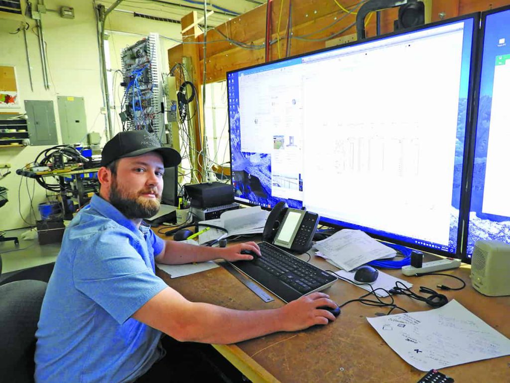 Tyler Stiles, systems installer, designs PLC layout for a system.