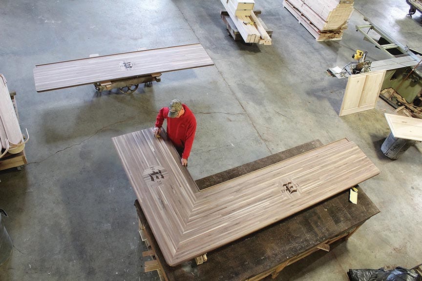 Douglas Long is shown working on a custom bar top for a local country club.